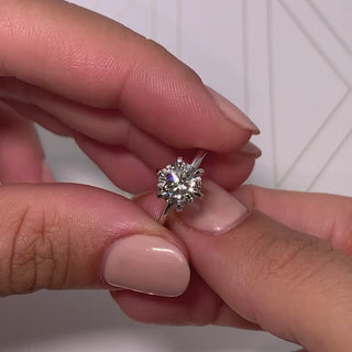 Gorgeous 2.0ct round solitaire moissanite ring shown on a finger