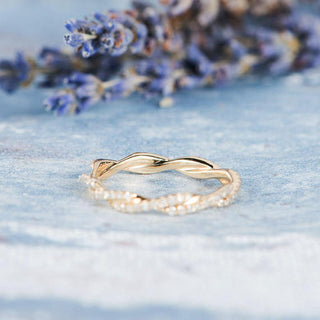 Refined round full eternity moissanite wedding band shown on a finger image 2