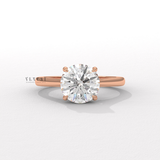 Hand model wearing a round brilliant moissanite engagement ring with a hidden halo and cathedral setting