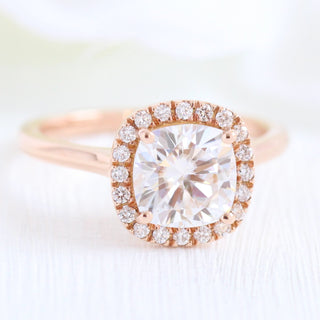 Delicate 2.30ct cushion halo moissanite ring shown on a finger