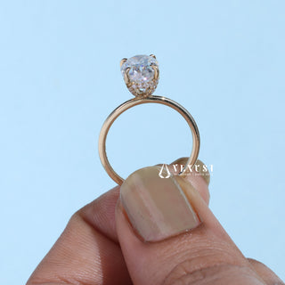 Gorgeous 1.0ct oval hidden halo moissanite ring shown on a finger