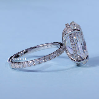 Oval Cut Moissanite Pave Hidden Halo Engagement Ring resting on its side showing the slim band