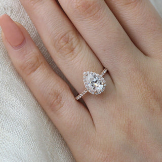Stunning 1.50ct pear halo moissanite ring tilted view catching the light
