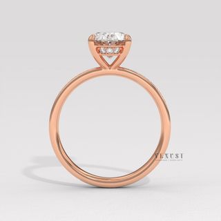 Hand model wearing a oval cut moissanite engagement ring with a hidden halo and pave band