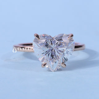 Solitaire Heart Shaped Moissanite Engagement Ring resting on its side showing the slim band