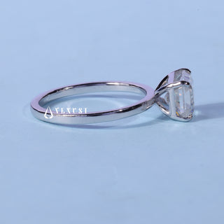 Solitaire Moissanite East West Emerald Cut Ring resting on its side showing the slim band