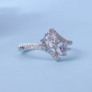 Round Cut Moissanite Tension Two Stone Engagement Ring resting on its side showing the slim band