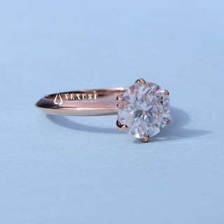 Solitaire Round Cut Moissanite Ring resting on its side showing the slim band