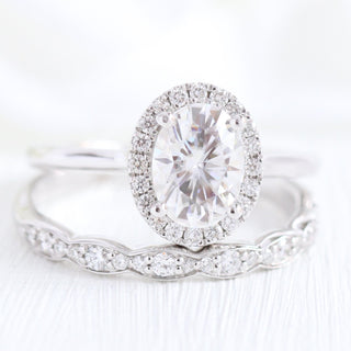 Vintage 1.50ct oval halo moissanite ring shown on a finger