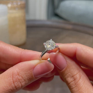 Radiant 2.0ct round solitaire moissanite ring shown on a finger