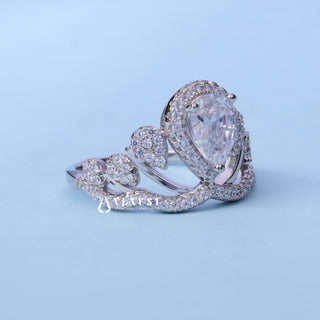 Halo Cluster Pear Cut Moissanite Engagement Ring resting on its side showing the slim band