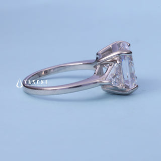 Three Stone Moissanite Asscher Cut Engagement Ring resting on its side showing the slim band