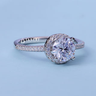 Halo Pave Round Cut Moissanite Engagement Ring resting on its side showing the slim band