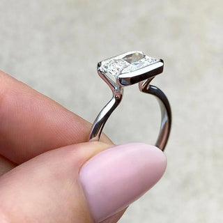 Sparkling 1.91ct emerald solitaire moissanite ring tilted view catching the light
