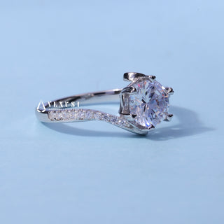 Tension Pave Round Cut Moissanite Engagement Ring resting on its side showing the slim band