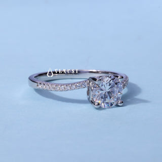 Petite Tension Pave Round Cut Moissanite Ring resting on its side showing the slim band