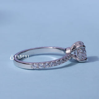 Round Cut Moissanite Pave Hidden Halo Engagement Ring resting on its side showing the slim band