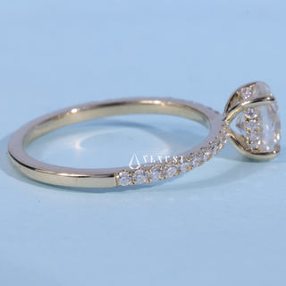 Pave Oval Cut Moissanite Engagement Ring resting on its side showing the slim band
