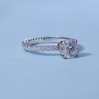 Front standing view of the Round Cut Moissanite Pave Hidden Halo Engagement Ring showing the prong setting
