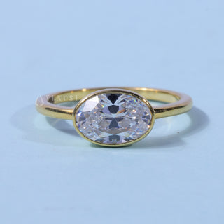 Bezel Oval Cut East West Moissanite Engagement Ring front view with upright centre stone