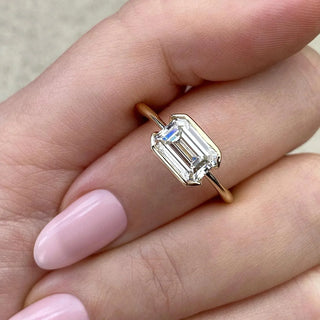 Classic 1.91ct emerald solitaire moissanite ring shown on a finger