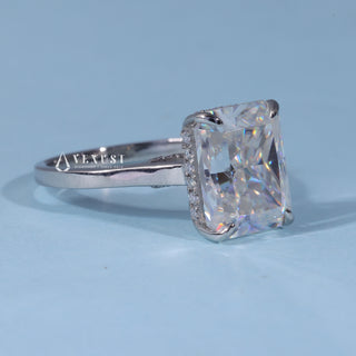 Radiant Hidden Halo Moissanite Cathedral Engagement Ring resting on its side showing the slim band