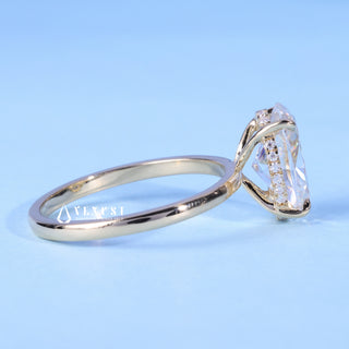 Oval Cut Moissanite Hidden Halo Solitaire Ring resting on its side showing the slim band