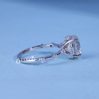 Oval Cut Moissanite Petite Pave Engagement Ring resting on its side showing the slim band