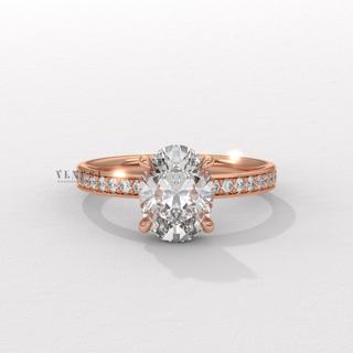Three-quarter angle of a oval cut moissanite engagement ring with a hidden halo and pave band