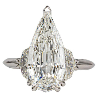 three stone moissanite engagement ring elongated pear front view