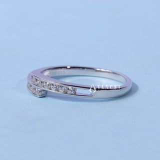 Brilliant round pave moissanite wedding band shown on a finger
