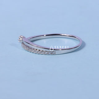 Shimmering round cluster moissanite wedding band shown on a finger