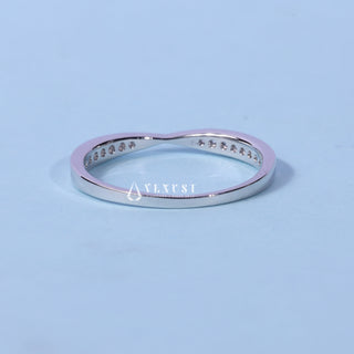 Refined round pave moissanite wedding band close up of the setting