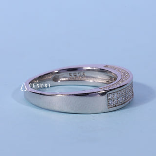 Bold round pave moissanite wedding band angled view showing its sparkle