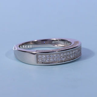 Bold round pave moissanite wedding band shown on a finger