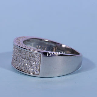Delicate round pave moissanite wedding band close up of the setting