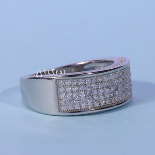 Delicate round pave moissanite wedding band shown on a finger