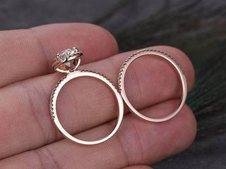 Lustrous 1.0ct pear halo moissanite ring shown on a finger
