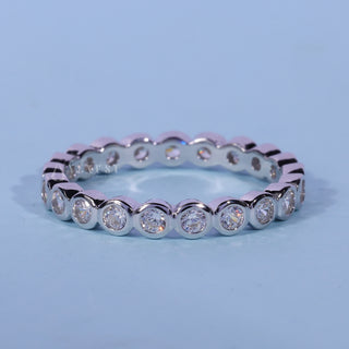 Gorgeous round bezel moissanite wedding band front view