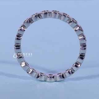 Gorgeous round bezel moissanite wedding band angled view showing its sparkle