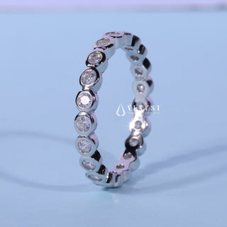 Gorgeous round bezel moissanite wedding band side profile view