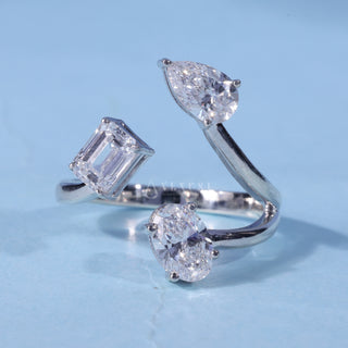 Emerald Oval Pear Three Stone Moissanite Engagement Ring front view with upright centre stone