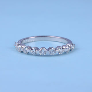 Delicate round half eternity moissanite wedding band front view