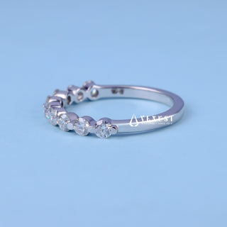Delicate round half eternity moissanite wedding band side profile view