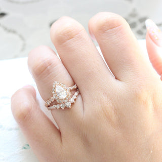 Refined 1.0ct pear halo moissanite ring front view