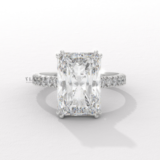 Front view of a radiant cut moissanite engagement ring with a pave band from a high angle
