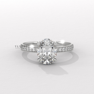 Macro shot of the centre stone on a oval cut moissanite engagement ring with a hidden halo and pave band