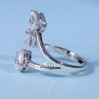 Front standing view of the Emerald Oval Pear Three Stone Moissanite Engagement Ring showing the prong setting