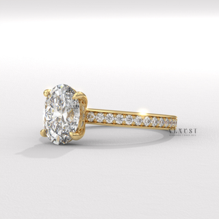 Oval cut moissanite engagement ring with a hidden halo and pave band worn on a hand