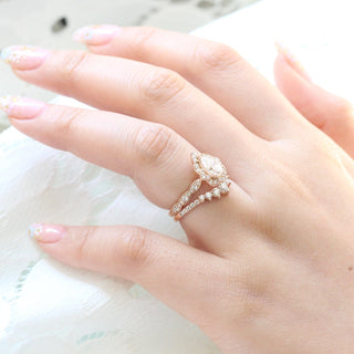 Refined 1.0ct pear halo moissanite ring shown on a finger